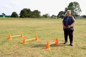 Lorna posing next to a set of jumps