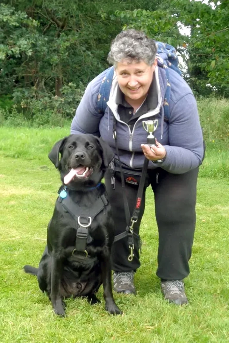 Lorna with her previous black Labrador, Sam, after winning a competition.