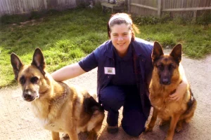 Susan with her previous dogs, Kyle and Ciara, both German Shepherds.